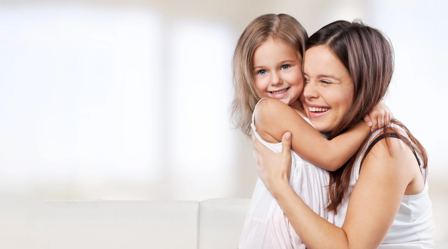 happy mother and daughter hugging and smiling